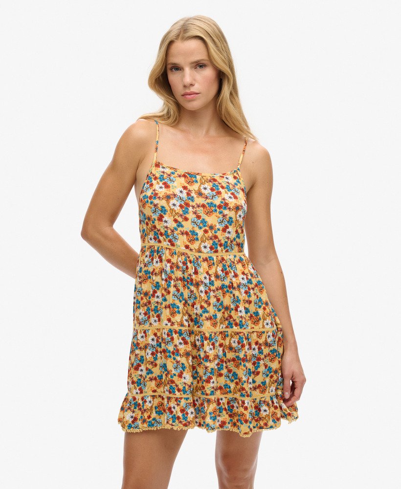 mini vestido de alcinha para praia em estampa floral amarela estilo anos 70.