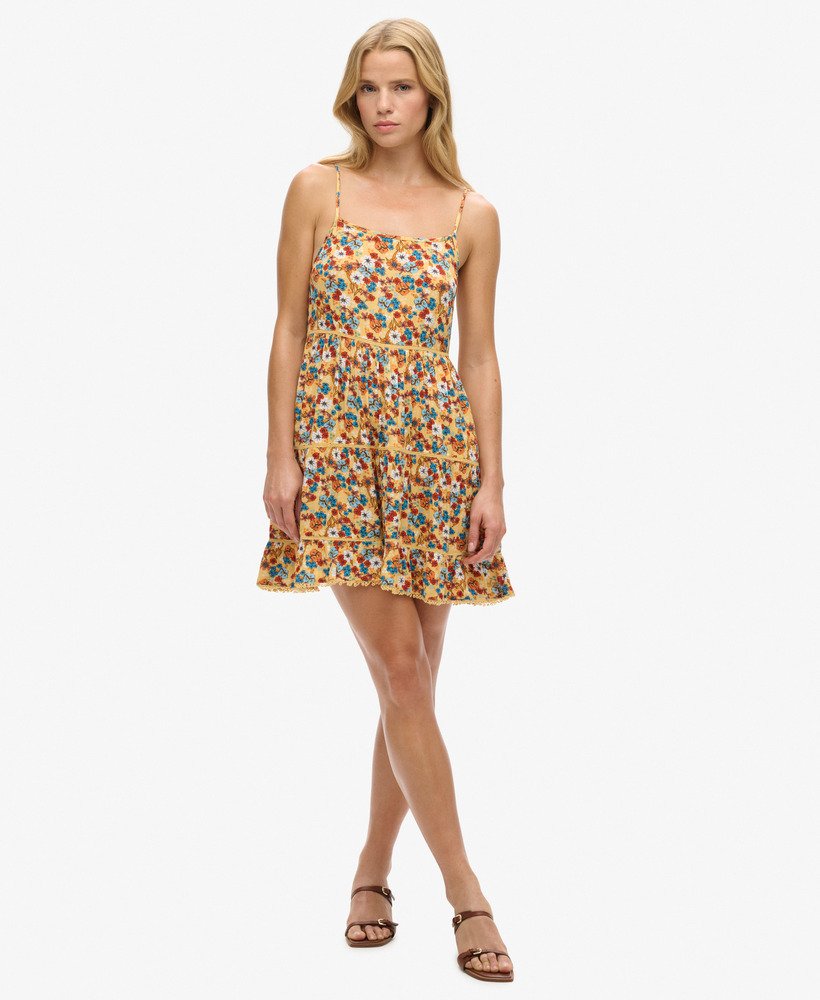 mini vestido de alcinha para praia em estampa floral amarela estilo anos 70.
