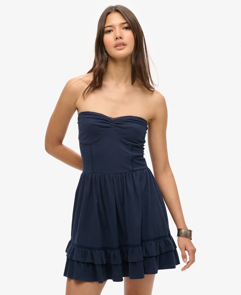 vestido curto bandeau de renda estilo anos 50 em um tom azul marinho intenso.