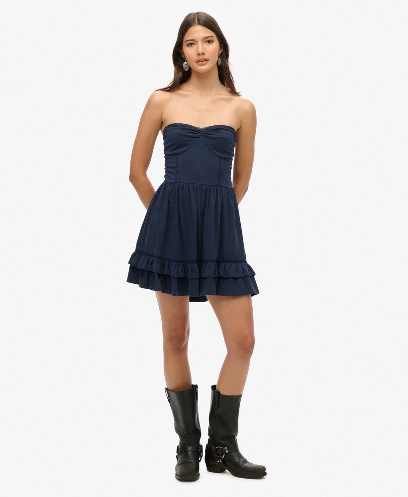 vestido curto bandeau de renda estilo anos 50 em um tom azul marinho intenso.