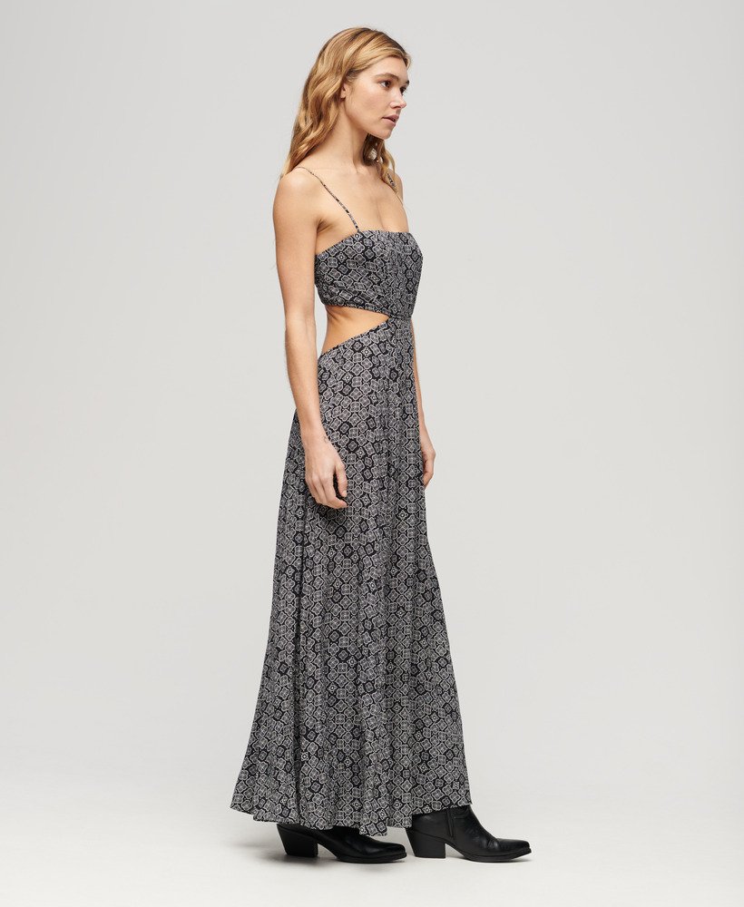vestido longo com costas transparentes em preto com estampa geométrica dos anos 70.