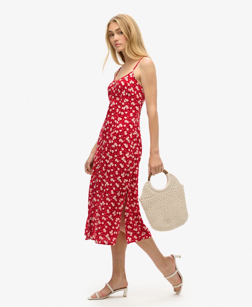 vestido midi de alcinha com estampa floral miúda em tons de rosa e fechamento frontal por botões.
