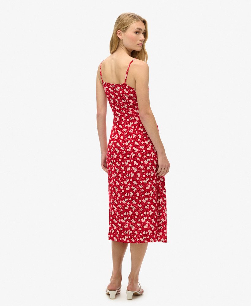 vestido midi de alcinha com estampa floral miúda em tons de rosa e fechamento frontal por botões.