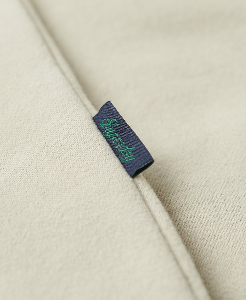jaqueta esportiva essential logo com zíper na cor bege claro.