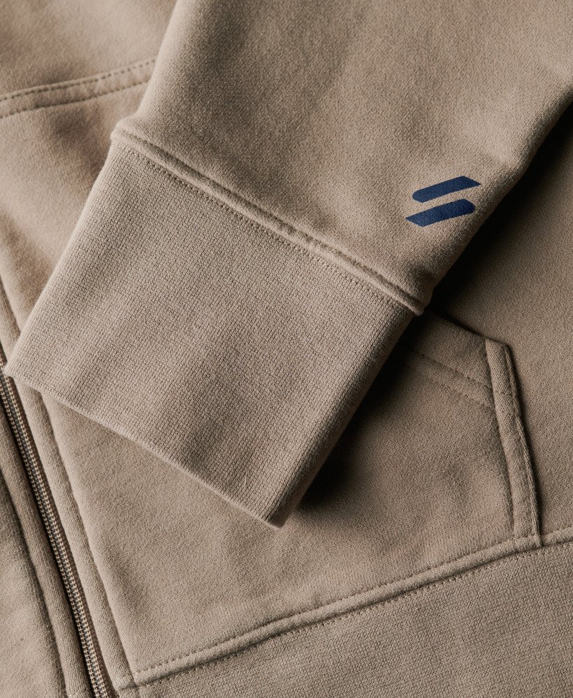 moletom com capuz e zíper estilo folgado com logo da sportswear em tecido texturizado bege escuro.