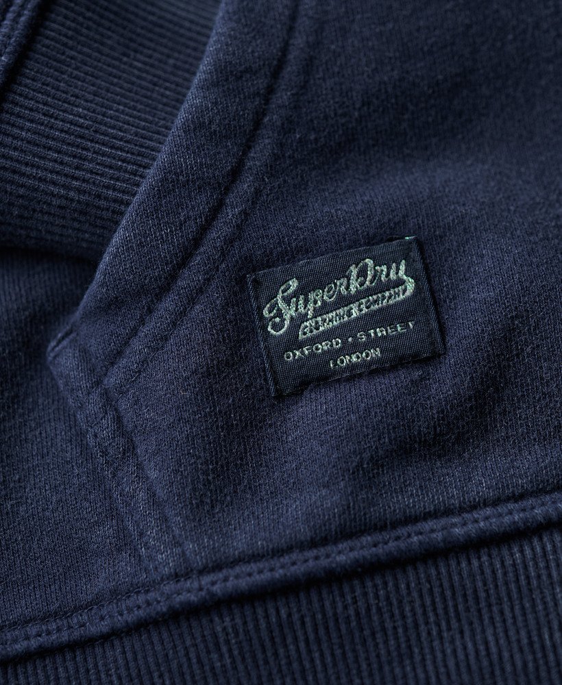 moletom com zíper e detalhes bordados em azul marinho intenso.