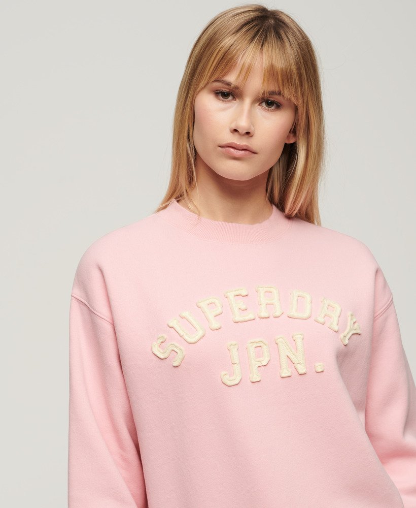 moletom folgado esportivo com apliques na cor rosa romance.