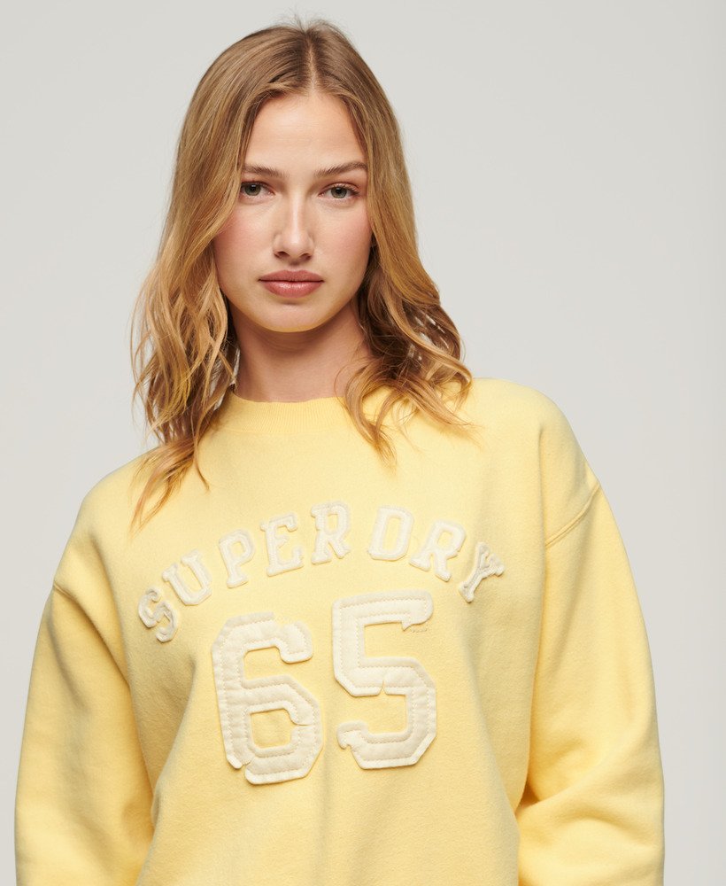 moletom esportivo folgado com apliques em amarelo claro