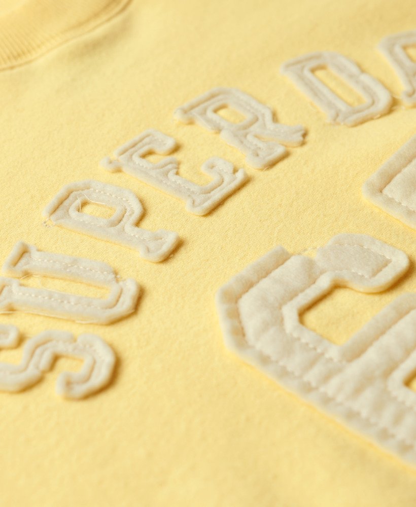 moletom esportivo folgado com apliques em amarelo claro