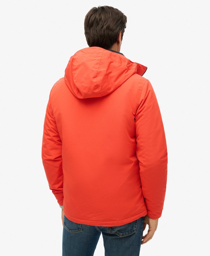 jaqueta corta-vento ultimate sd com capuz na cor laranja vibrante.