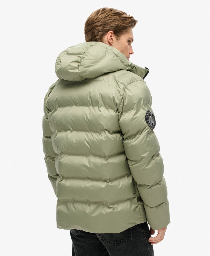 jaqueta puffer com capuz e estampa da cidade na cor verde-marinho.