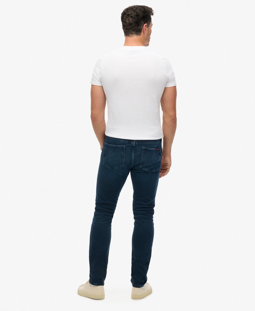calça jeans vintage slim na cor vanderbilt ink com efeito desgastado.