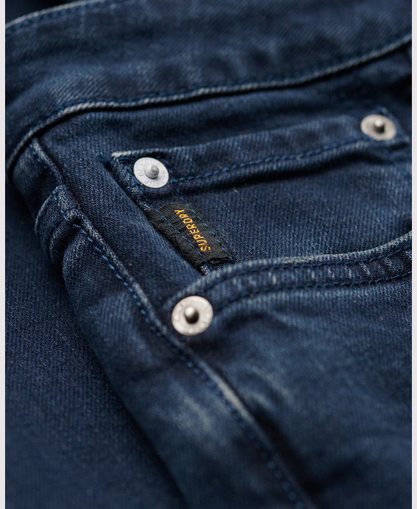 calça jeans vintage slim na cor vanderbilt ink com efeito desgastado.
