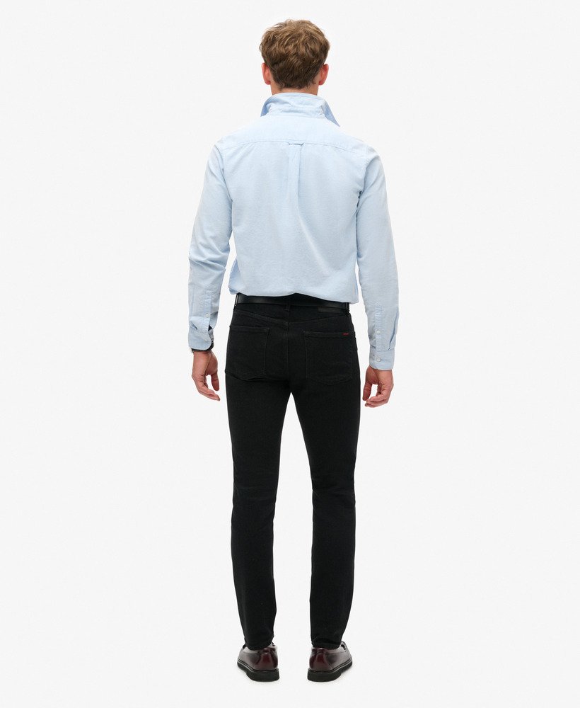 calça jeans vintage slim na cor preta lavada venom.