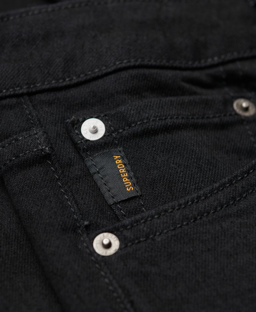 calça jeans vintage slim na cor preta lavada venom.