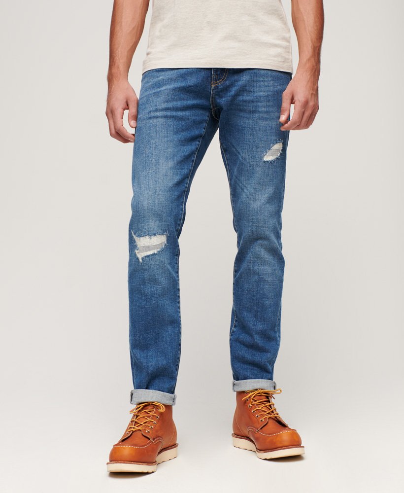 calça jeans vintage slim na cor stanton azul brilhante com rasgos.