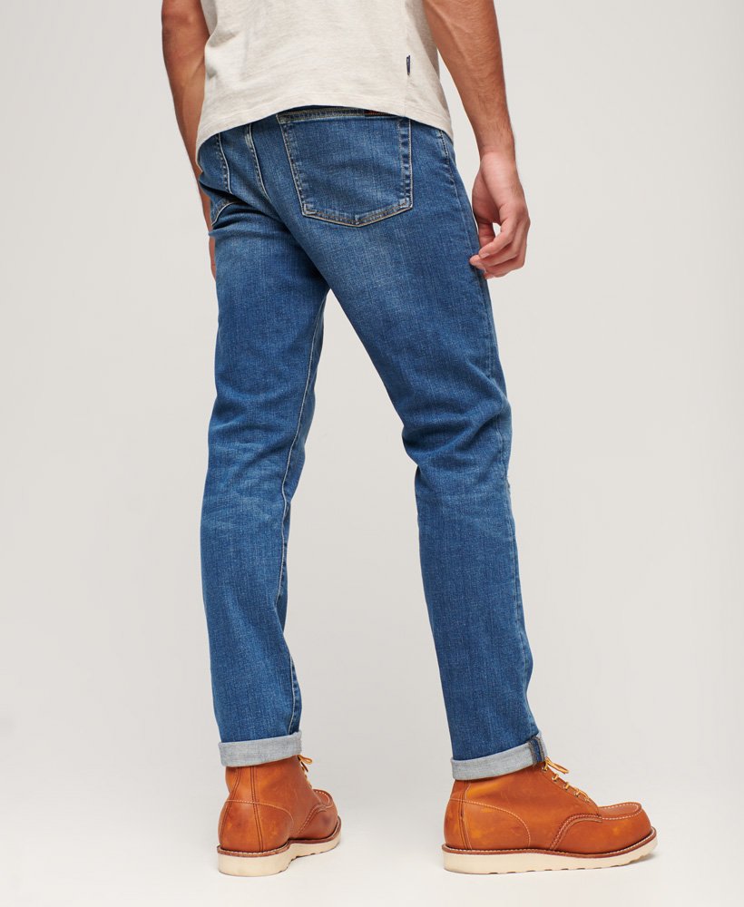 calça jeans vintage slim na cor stanton azul brilhante com rasgos.