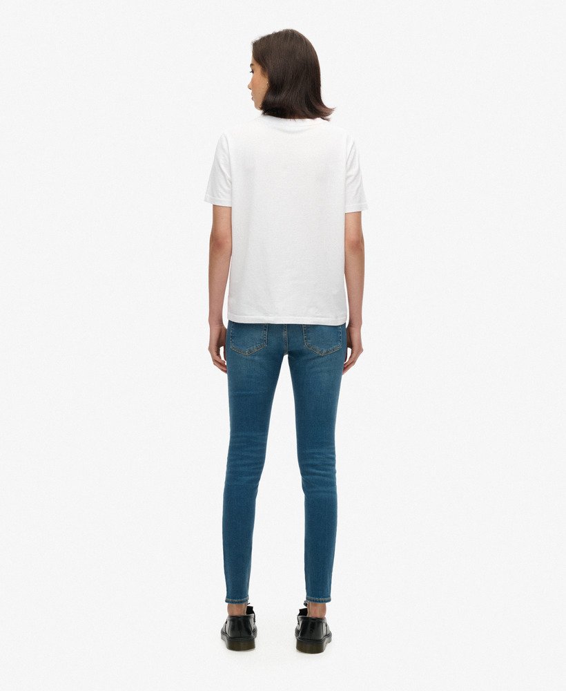 calça jeans skinny vintage de algodão orgânico com cintura média na cor azul vintage fulton.