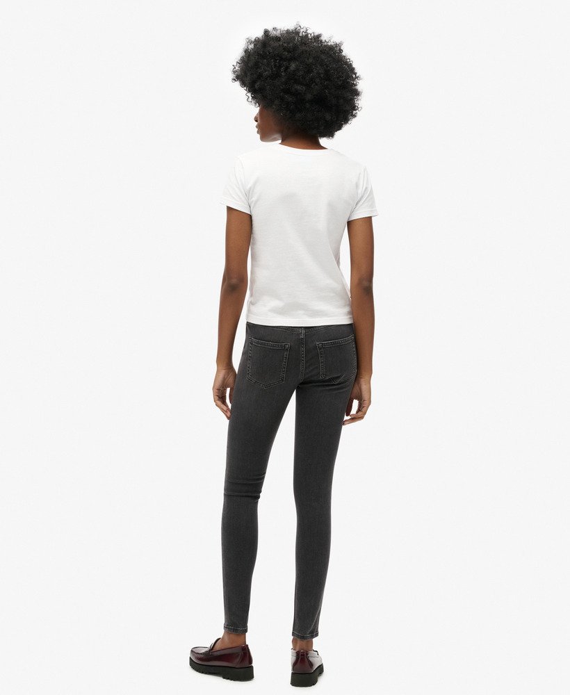 calça jeans skinny vintage de algodão orgânico com cintura média na cor walcott black stone.