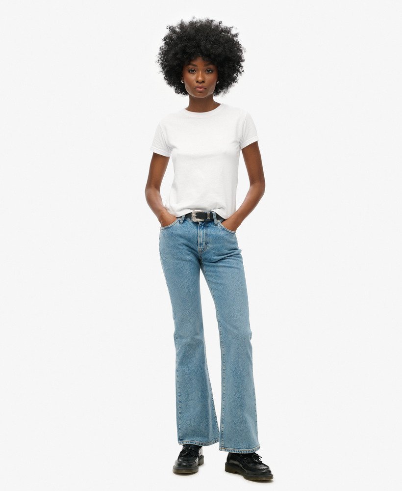 calça jeans vintage de cintura média corte flare slim em índigo escuro envelhecido.
