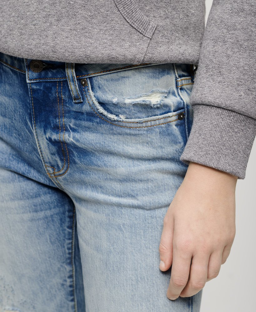 calça jeans slim de cintura média em algodão orgânico na cor azul cânion.