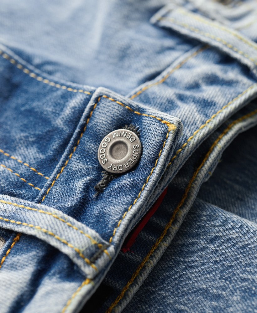 calça jeans slim de cintura média em algodão orgânico na cor azul cânion.