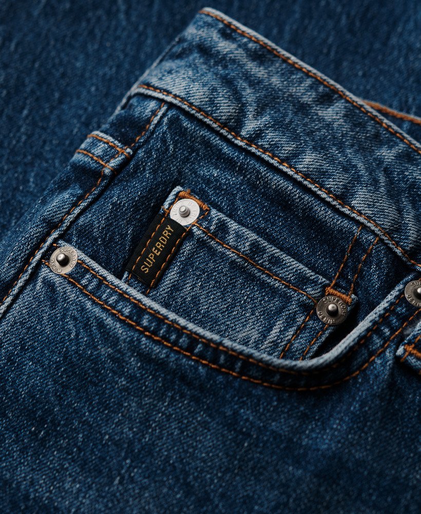 calça jeans slim de cintura média em algodão orgânico na cor azul valley.