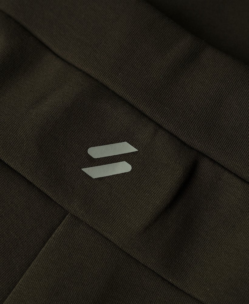 calças de corrida sport tech tapered na cor cáqui militar.