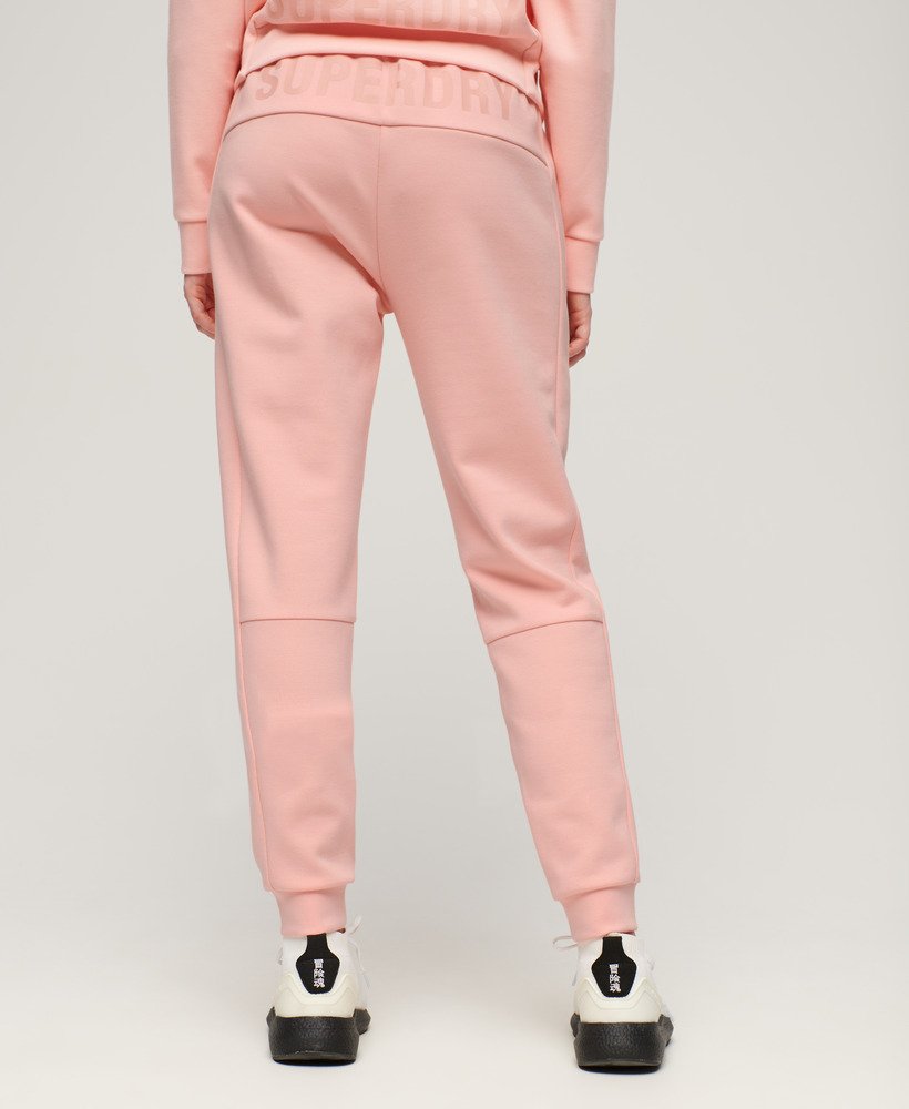 calça de moletom sports tech slim na cor rosa pêssego perolado