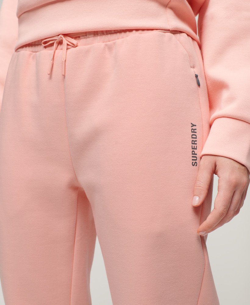 calça de moletom sports tech slim na cor rosa pêssego perolado