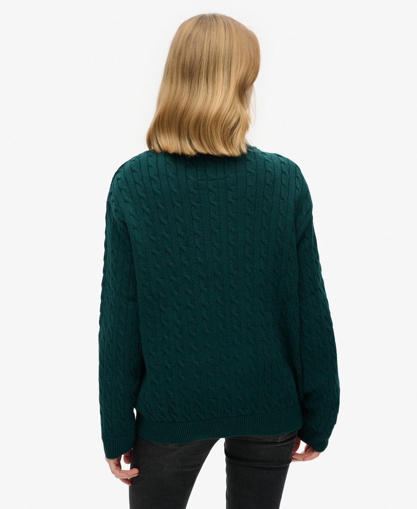 suéter oversized com decote em v e tranças na cor verde pinho escuro.