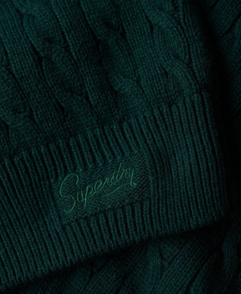 suéter oversized com decote em v e tranças na cor verde pinho escuro.