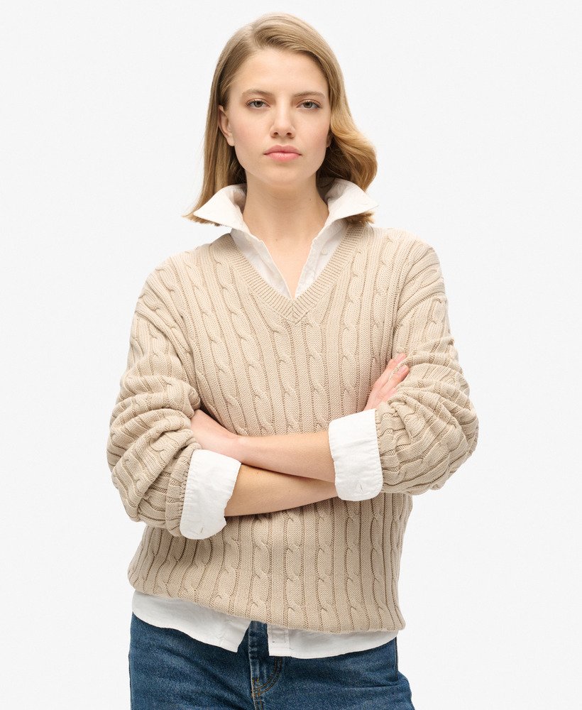 blusa oversized com decote em v e tranças na cor bege aveia.