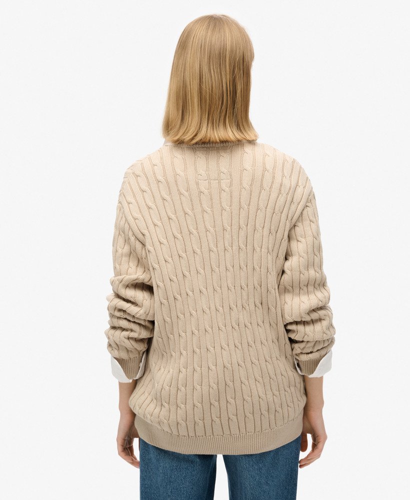 blusa oversized com decote em v e tranças na cor bege aveia.