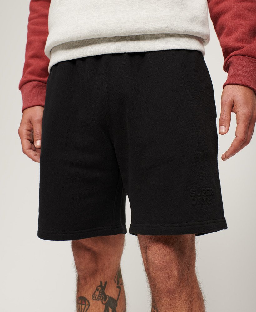 calções folgados com relevo da sportswear na cor preta.