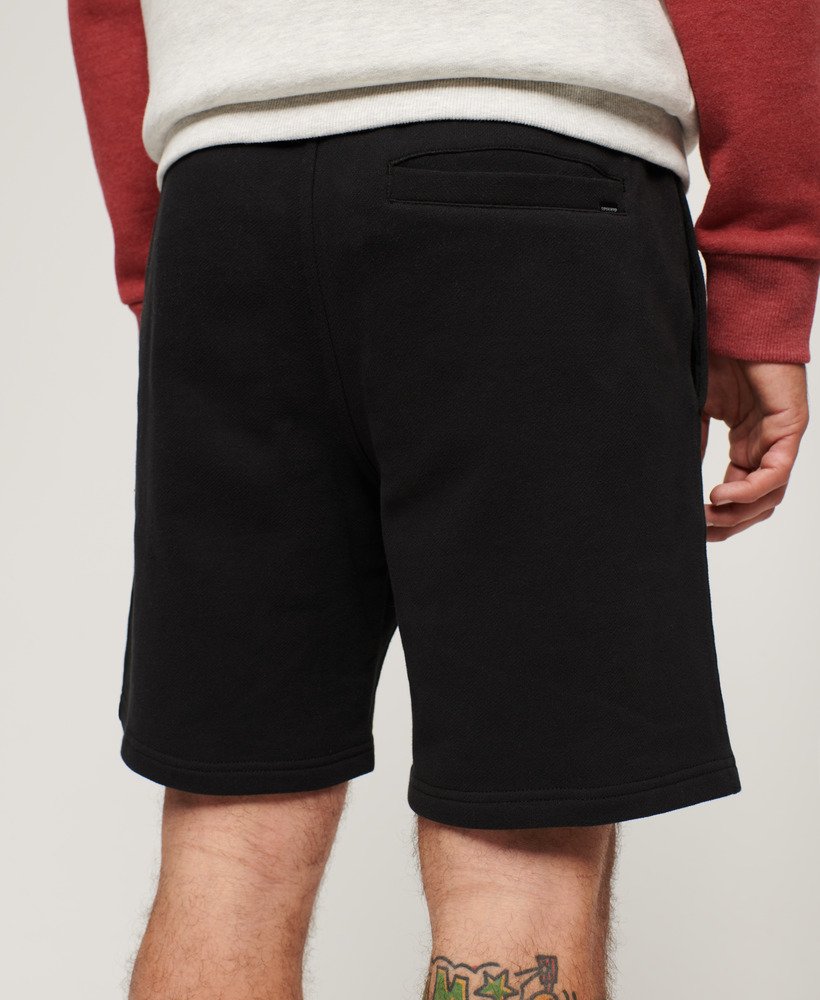 calções folgados com relevo da sportswear na cor preta.