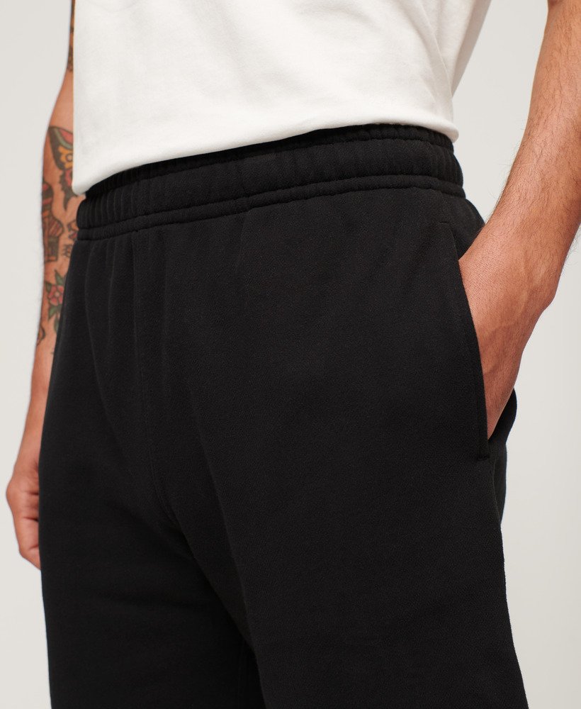 calções folgados com relevo da sportswear na cor preta.