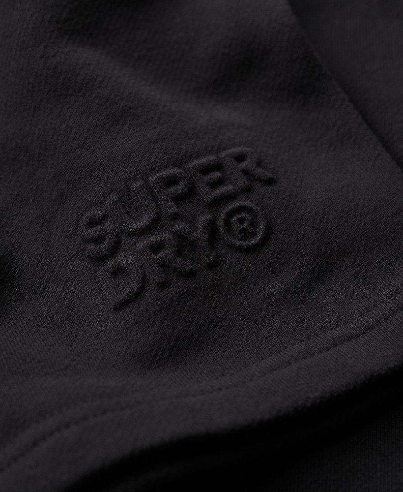 calções folgados com relevo da sportswear na cor preta.