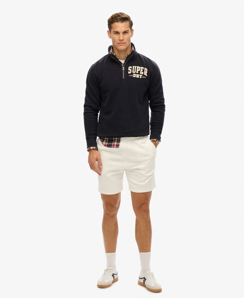 calções folgados com relevo da sportswear na cor branca giz.