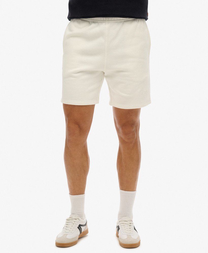 calções folgados com relevo da sportswear na cor branca giz.