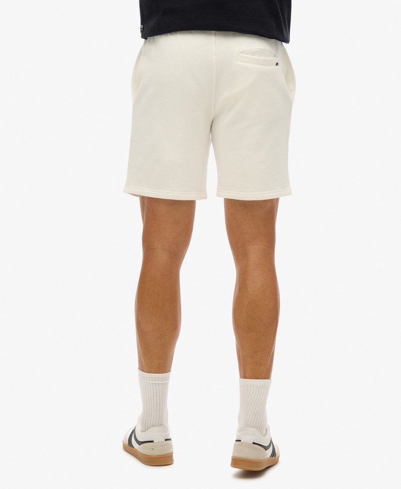 calções folgados com relevo da sportswear na cor branca giz.