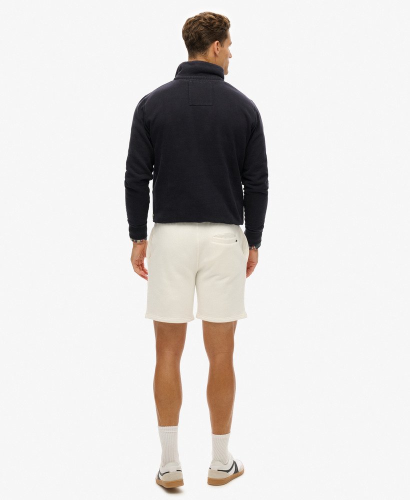calções folgados com relevo da sportswear na cor branca giz.