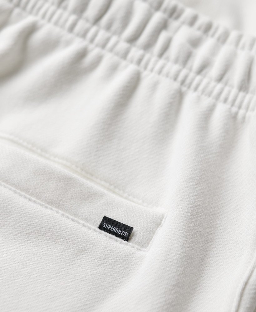 calções folgados com relevo da sportswear na cor branca giz.