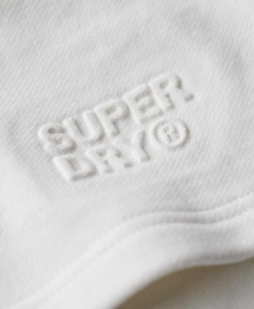 calções folgados com relevo da sportswear na cor branca giz.