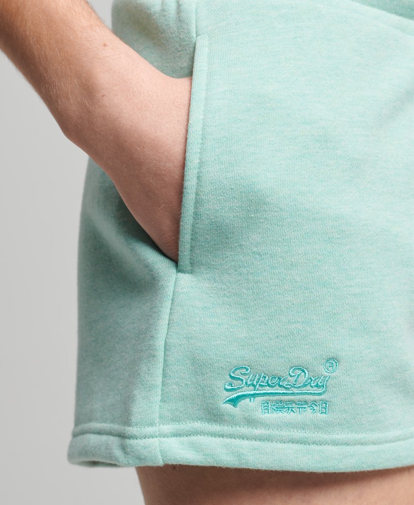shorts de malha com logo vintage em algodão orgânico na cor verde menta mesclado.