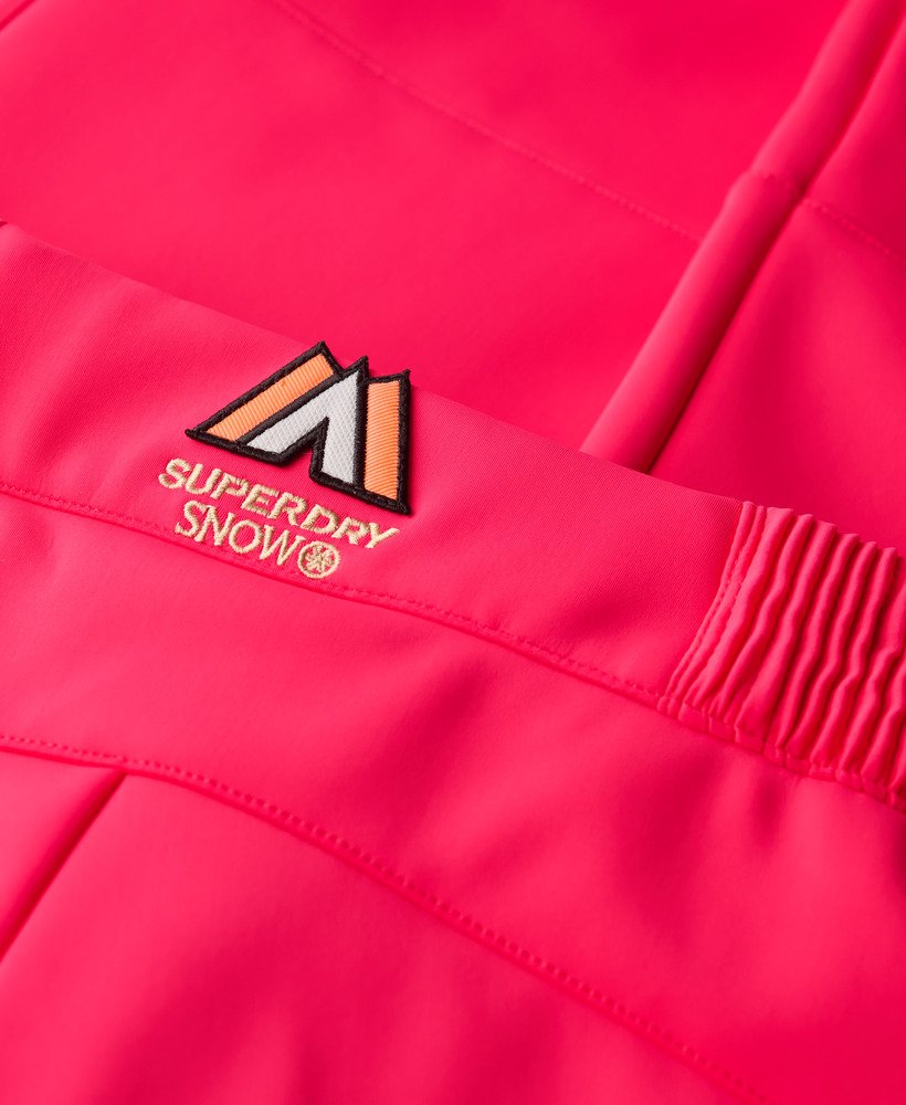 calças de esqui slim em softshell na cor rosa vibrante.