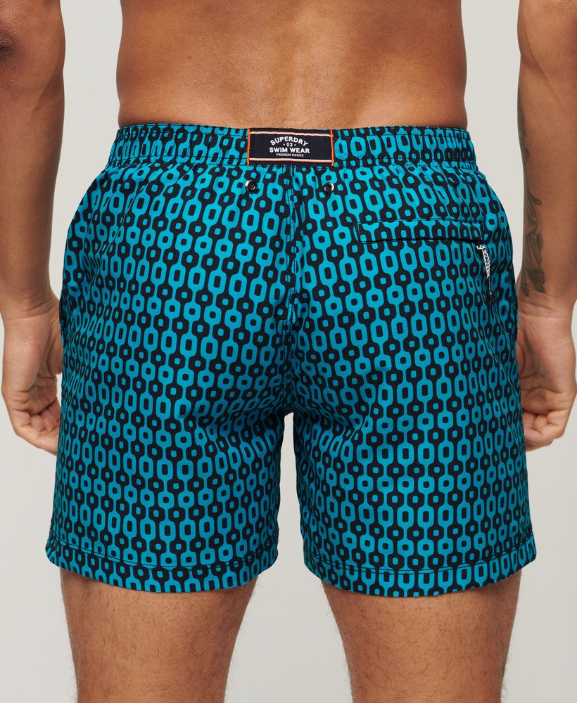 calção de banho reciclado estampado com padrão geométrico azul-marinho medindo 38 cm 15 polegadas.