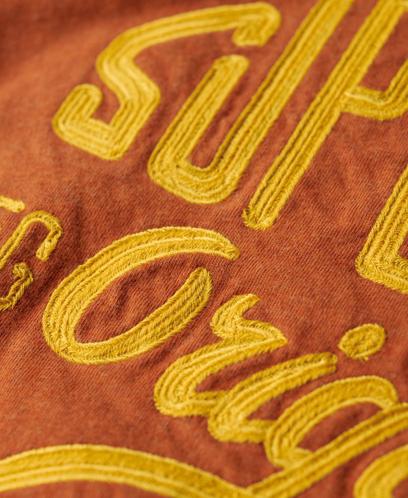 camiseta com estampa esportiva em estilo script na cor laranja ferrugem mesclado.