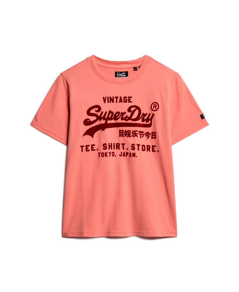 camiseta clássica vintage com estampa de logo e modelagem relaxada na cor coral queimado.