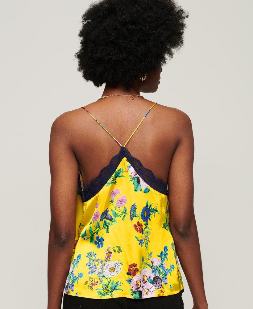 top de alças em cetim com detalhes em renda e estampa floral amarela vibrante.